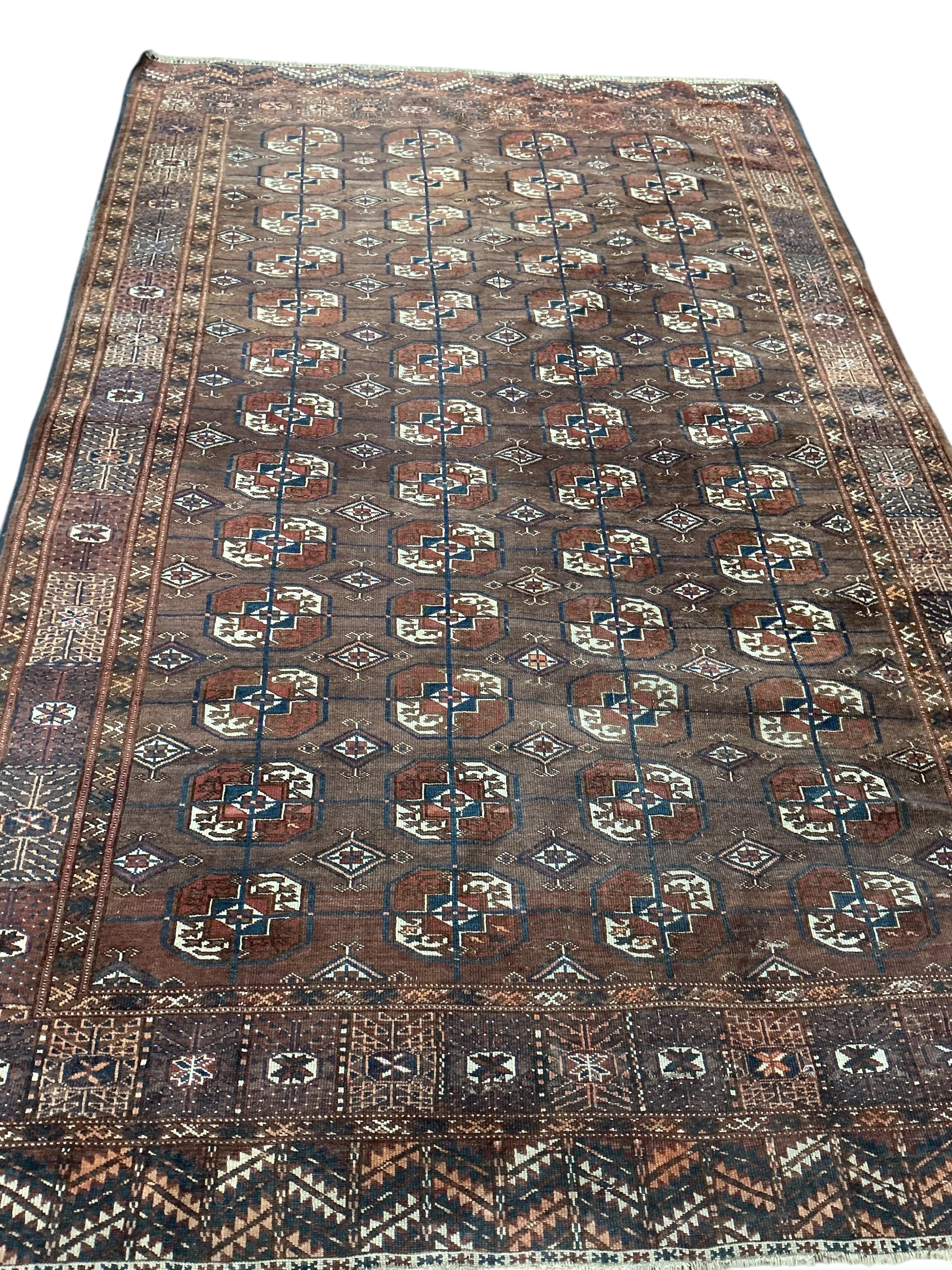 A Tekke Turkoman burgundy ground rug, 260 x 166cm